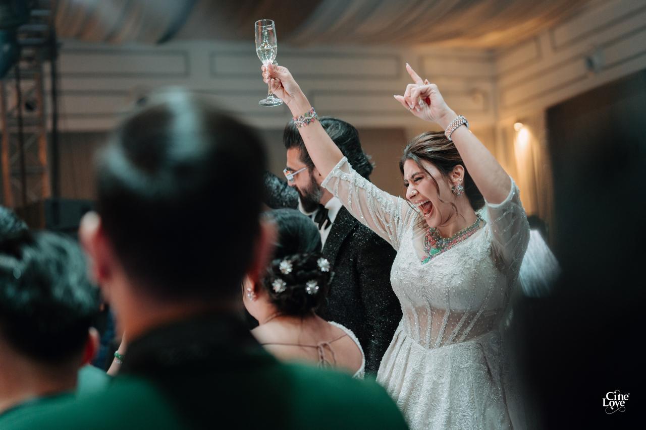 A client dancing with her husband beside her at their celebration