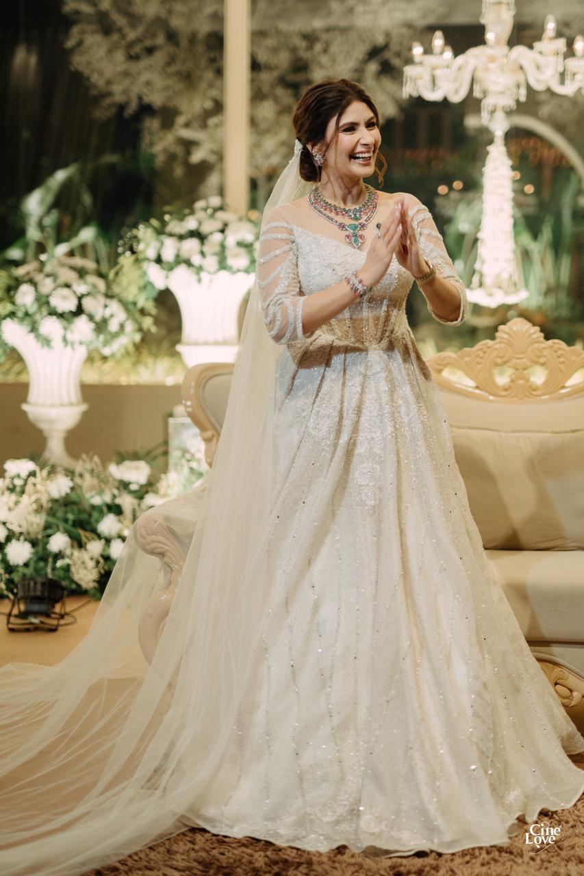A client wearing her ivory gown at her celebration